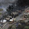 CFA firefighters work on spot fires in the Yarra Valley after fires swept through.