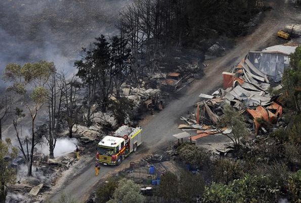 CFA firefighters work on spot fires in the Yarra Valley after fires swept through.